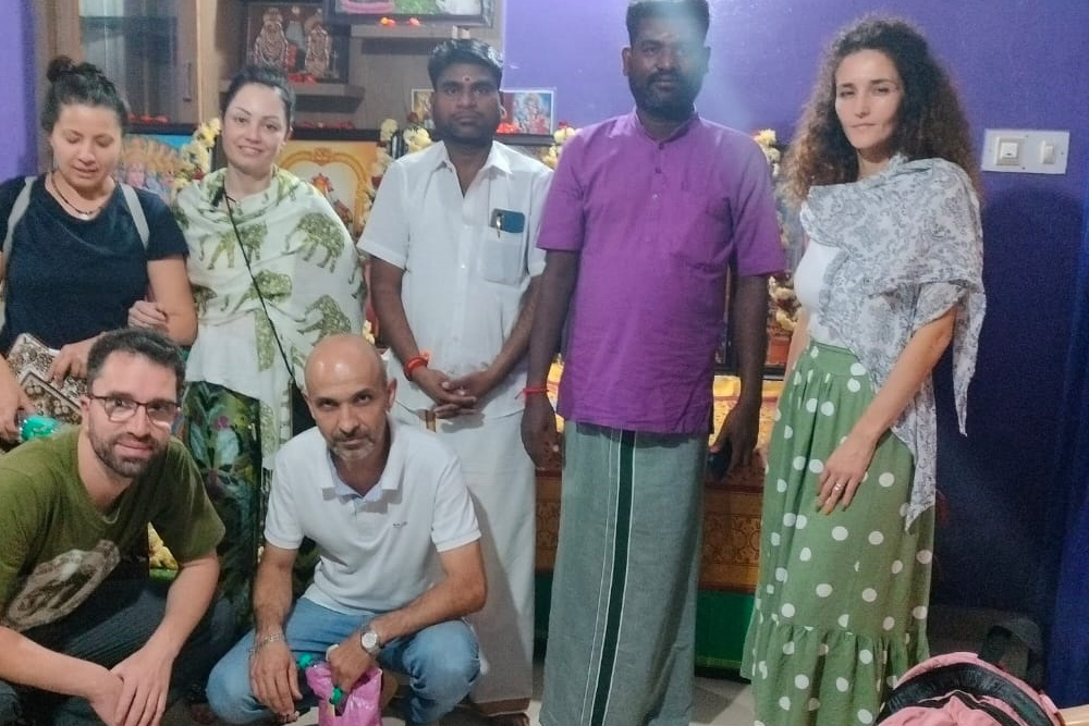 A Nadi reader explaining a palm leaf reading to a client
